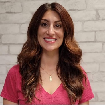A person smiling for the cameraDescription automatically generated with medium confidence